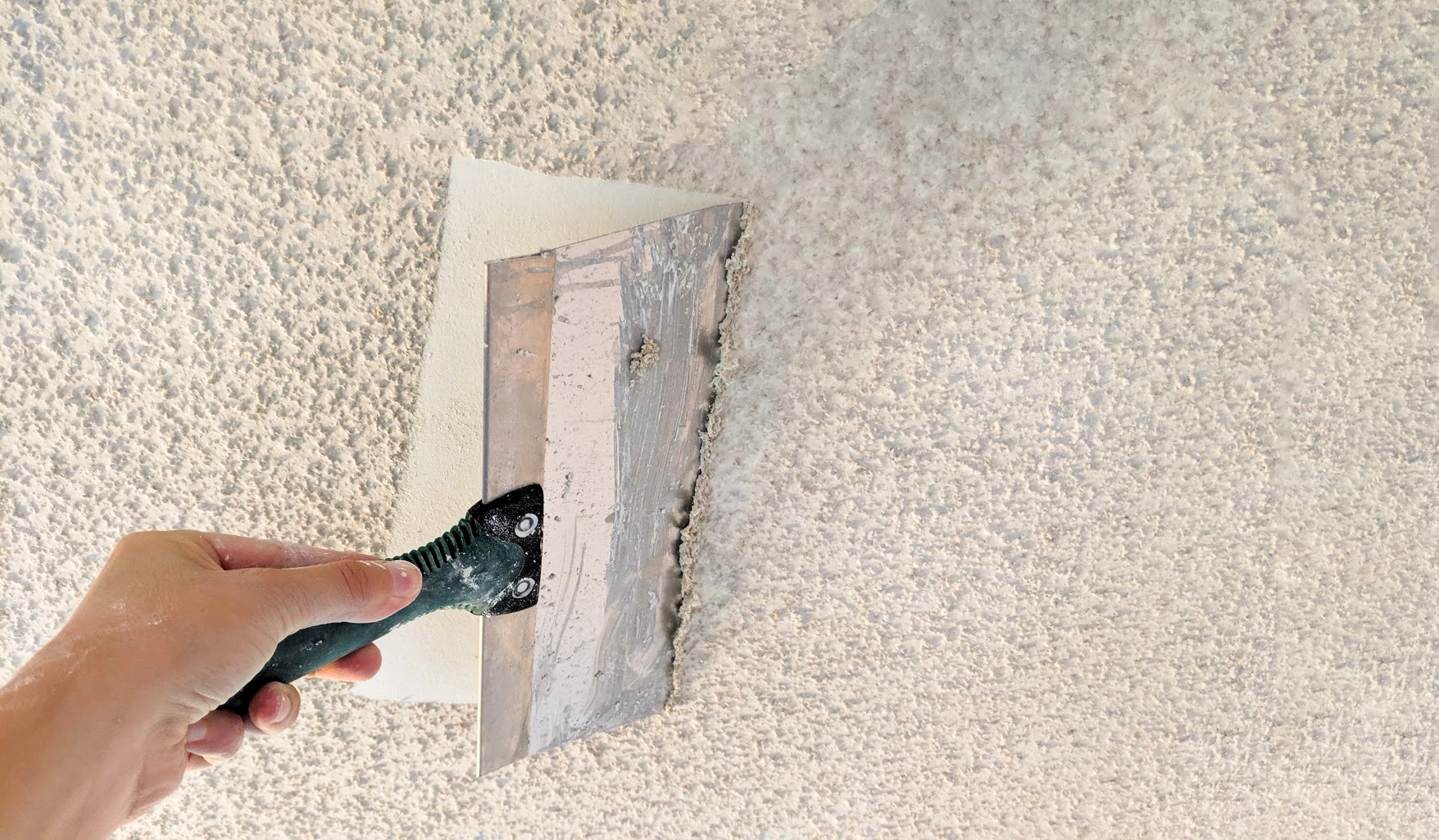 Scraping is one of the most common methods for removing painted popcorn or textured ceiling